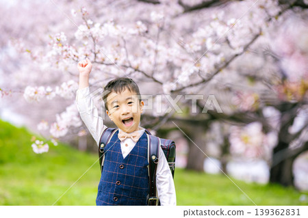 A boy carrying a school bag A boy carrying a school bag 139362831