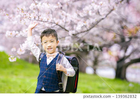 A boy carrying a school bag A boy carrying a school bag 139362832