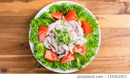 Pork shabu-shabu salad, a refreshing cold shabu-shabu salad with lettuce and tomatoes, served on a wooden table. Pork shabu-shabu salad, a refreshing cold shabu-shabu salad with lettuce and tomatoes, served on a wooden table. 139362951
