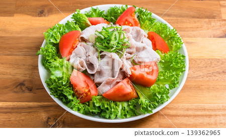Pork shabu-shabu salad, a refreshing cold shabu-shabu salad with lettuce and tomatoes, served on a wooden table. Pork shabu-shabu salad, a refreshing cold shabu-shabu salad with lettuce and tomatoes, served on a wooden table. 139362965