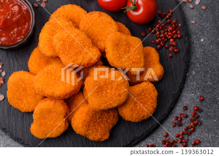 Fried chicken nuggets with sauce, salt, and spices, fast food, unhealthy food. Chicken nuggets Fried chicken nuggets with sauce, salt, and spices, fast food, unhealthy food. Chicken nuggets 139363012