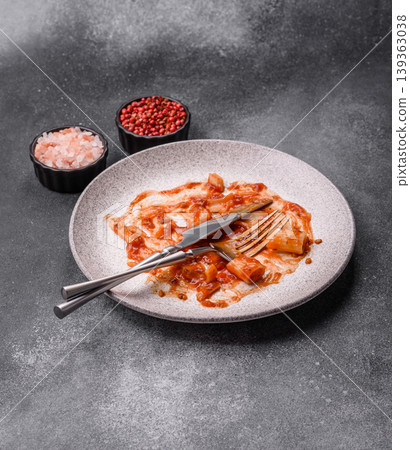 A dirty plate after a meal with leftover pasta and tomato sauce, cleaning. An empty dirty plate A dirty plate after a meal with leftover pasta and tomato sauce, cleaning. An empty dirty plate 139363038