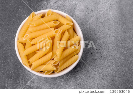 Italian uncooked dry penne regate pasta ready for cooking. Dry penne pasta 139363046