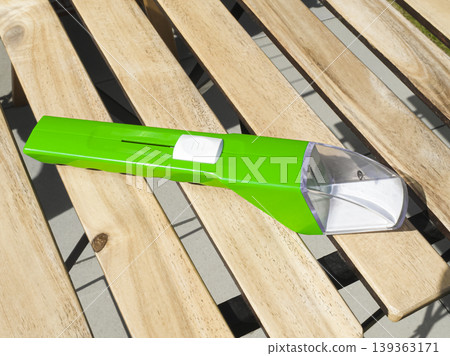 Green insect and spider catcher with a transparent capture section, presenting a simple solution for safe insect handling. 139363171