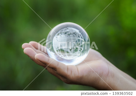 Renewable energy concept Earth Day or environment protection Hands protect forests that grow on the ground and help save the world. Renewable energy concept Earth Day or environment protection Hands protect forests that grow on the ground and help save the world. 139363502