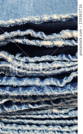 A close-up of a stack of blue denim jeans A close-up of a stack of blue denim jeans 139363716