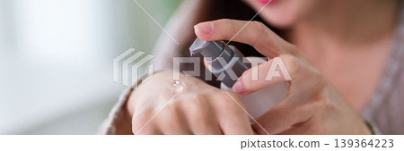Asian women applying hand sanitizer gel on hands hygiene skincare routine clean sanitizing antibacterial product for healthy lifestyle wellness protection at Asian women applying hand sanitizer gel on hands hygiene skincare routine clean sanitizing antibacterial product for healthy lifestyle wellness protection at 139364223