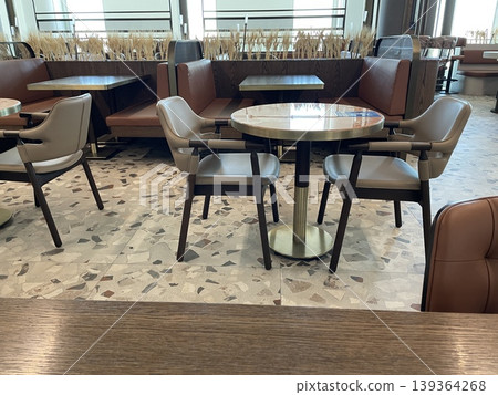 Empty restaurant seating area with round tables and modern chairs as dining background Empty restaurant seating area with round tables and modern chairs as dining background 139364268