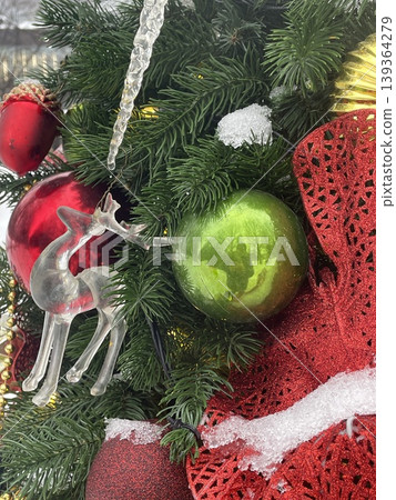 Christmas tree adorned with ornaments, icicle, and snow for festive holiday background Christmas tree adorned with ornaments, icicle, and snow for festive holiday background 139364279