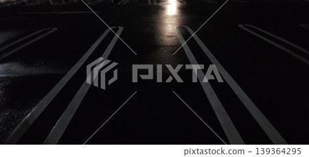 Minimalist background image of a wet road and white lines at night. Minimalist background image of a wet road and white lines at night. 139364295