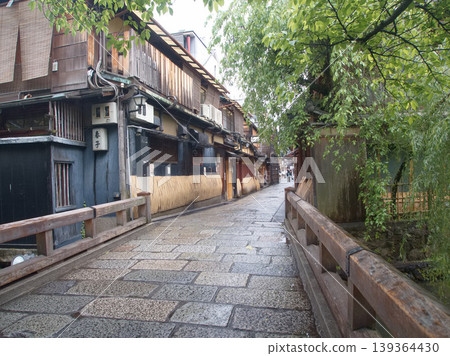 從祗園白川上的辰巳橋,周圍綠樹環繞,一直延伸到山隘。 從祗園白川上的辰巳橋,周圍綠樹環繞,一直延伸到山隘。 139364430