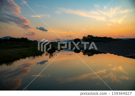 Tamaki Town, Mie Prefecture: Tamaki Waterside School - Image of the sunset reflected on the water's surface. Tamaki Town, Mie Prefecture: Tamaki Waterside School - Image of the sunset reflected on the water's surface. 139364827