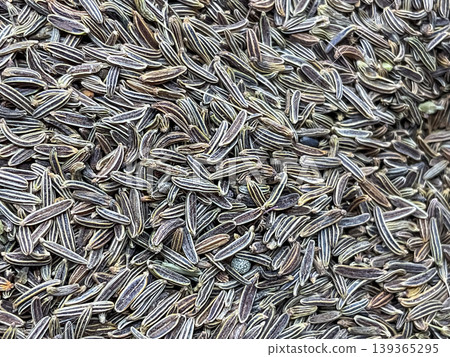 macro texture of dried caraway seeds. Caraway seeds, also commonly known as Shah Jeera or Kala Jeera in India. macro texture of dried caraway seeds. Caraway seeds, also commonly known as Shah Jeera or Kala Jeera in India. 139365295