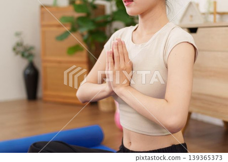 young Asian women meditation yoga pose prayer hands namaste gesture exercise fitness practice wellness healthy lifestyle relaxation mindfulness home indoor young Asian women meditation yoga pose prayer hands namaste gesture exercise fitness practice wellness healthy lifestyle relaxation mindfulness home indoor 139365373