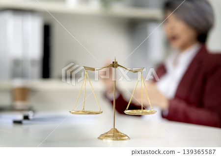Asian adult professional woman legal office justice balance scale concept fairness equity principles Asian adult professional woman legal office justice balance scale concept fairness equity principles 139365587