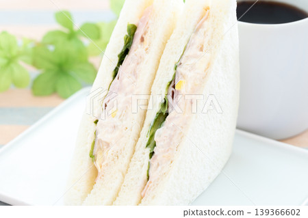 A delicious ham, tuna, and lettuce sandwich and coffee for breakfast. A delicious ham, tuna, and lettuce sandwich and coffee for breakfast. 139366602