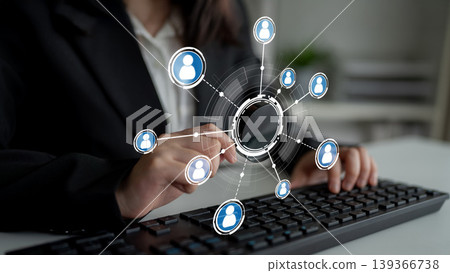 Business Professional Engaging with Digital Network Connections through Keyboard and Virtual User Icons in Modern Workspace Environment Crux Business Professional Engaging with Digital Network Connections through Keyboard and Virtual User Icons in Modern Workspace Environment Crux 139366738