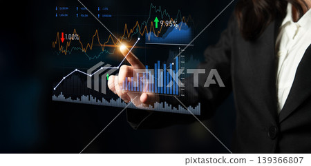 Business professional interacts with financial data on a transparent touchscreen, displaying stock market trends and analysis with graphs and statistics. Scalp Business professional interacts with financial data on a transparent touchscreen, displaying stock market trends and analysis with graphs and statistics. Scalp 139366807
