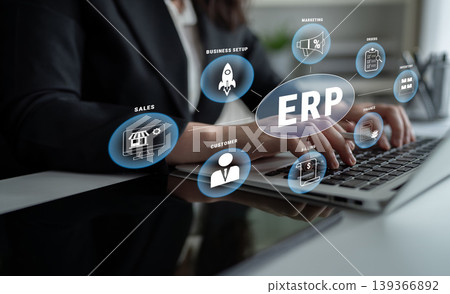 Business Professional Engaging with Modern Technology and ERP Software on Laptop with Various Business Icons Representing Strategy and Sales Growth Quark 139366892