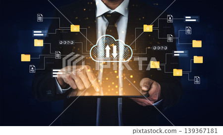 Businessman in suit interacting with digital tablet featuring cloud technology and data transfer, symbolizing modern information management and digital communication Gantry 139367181