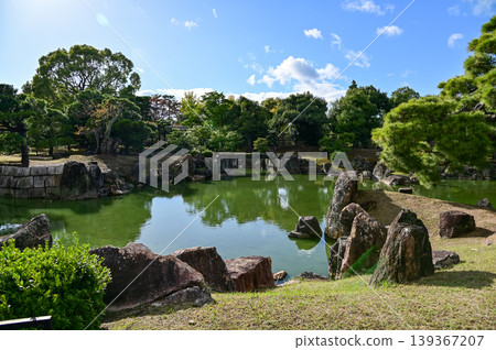 The Japanese gardern view of nijo jo castle, Kyoto, Japan. World Heritage Site, Japanese old traditional architecture in Kyoto, Japan. Background landscape of the beauty of Nijo Castle at sunny day. The Japanese gardern view of nijo jo castle, Kyoto, Japan. World Heritage Site, Japanese old traditional architecture in Kyoto, Japan. Background landscape of the beauty of Nijo Castle at sunny day. 139367207