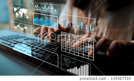 Close-up Image of Hands typing on a Keyboard with Digital Data Visualizations and Graphs Floating Above in a Modern Office Setting Gluon 139367310