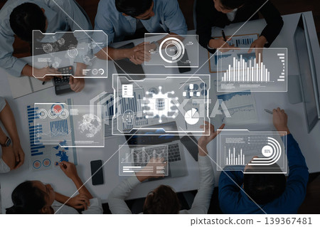 Team Collaboration in Data Analysis with Digital Charts and Graphs on Table for Business Strategy Evaluation and Decision Making Trope 139367481