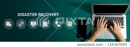 Hands Typing on Laptop during Disaster Recovery Process with Icons Representing Data Backup, Security, and Technology Solutions Ledger 139367604