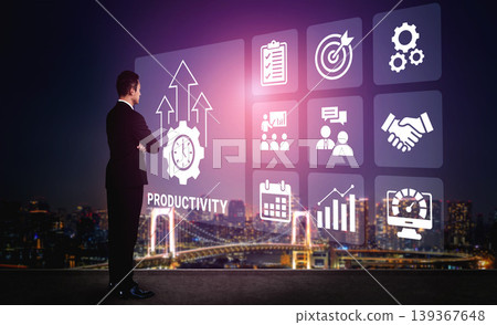Businessman Looking at Digital Productivity Icon Set with Graphs, Charts, and Symbols Against a City Skyline Background at Night Ledger Businessman Looking at Digital Productivity Icon Set with Graphs, Charts, and Symbols Against a City Skyline Background at Night Ledger 139367648