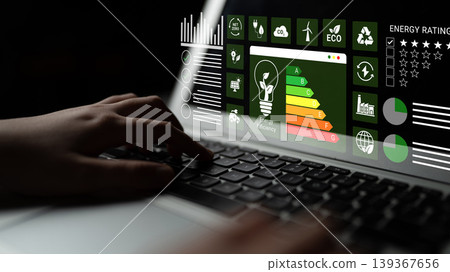 Digital Interface with Energy Efficiency Charts and Data Visualization on Laptop Keyboard at Night for Sustainable Technology Concepts Ledger Digital Interface with Energy Efficiency Charts and Data Visualization on Laptop Keyboard at Night for Sustainable Technology Concepts Ledger 139367656