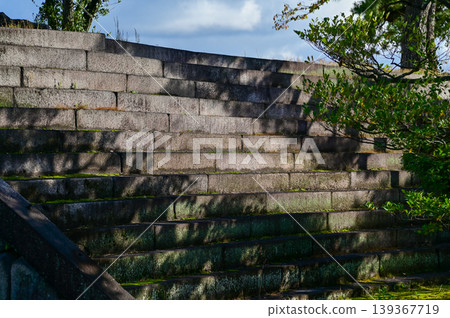 Close-up of the stairs with shadow in the sunny day in nijo jo castle, Kyoto, Japan. World Heritage Site. A corner of nijo jo castle. Background landscape of the beauty of Nijo Castle. Close-up of the stairs with shadow in the sunny day in nijo jo castle, Kyoto, Japan. World Heritage Site. A corner of nijo jo castle. Background landscape of the beauty of Nijo Castle. 139367719