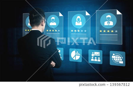 Business Professional Reviewing Digital Profiles and Data Analytics in Modern Workplace Setting with Graphic Displays and Interactive Interfaces Ledger Business Professional Reviewing Digital Profiles and Data Analytics in Modern Workplace Setting with Graphic Displays and Interactive Interfaces Ledger 139367812