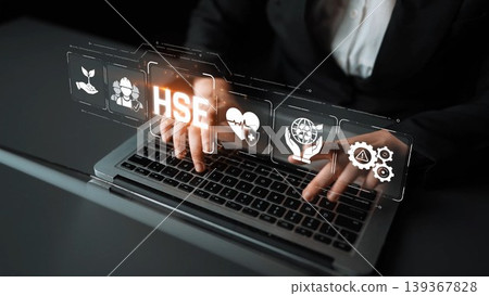 A business professional engages with technology on a laptop, showcasing health, safety, and environment concepts through elegant digital icons, emphasizing sustainability in modern practices. Sigmoid A business professional engages with technology on a laptop, showcasing health, safety, and environment concepts through elegant digital icons, emphasizing sustainability in modern practices. Sigmoid 139367828