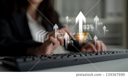 A businesswoman engages with her keyboard while analyzing data illustrated by digital growth arrows, symbolizing success and progress in a modern office environment. Sigmoid A businesswoman engages with her keyboard while analyzing data illustrated by digital growth arrows, symbolizing success and progress in a modern office environment. Sigmoid 139367890