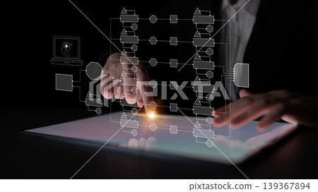 Business Professional Using Digital Tablet with Graphic Interface and Flowchart Concepts for Modern Analysis and Technology Solutions in Dark Setting Quark 139367894