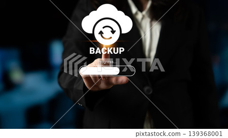 Business Professional Initiating Data Backup Process with Digital Interface and Cloud Symbol on Display Screen in Modern Office Environment Ledger Business Professional Initiating Data Backup Process with Digital Interface and Cloud Symbol on Display Screen in Modern Office Environment Ledger 139368001