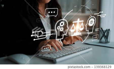 Business professional analyzing ethical implications of artificial intelligence while using keyboard with digital graphics representing balance and dialogue Gluon Business professional analyzing ethical implications of artificial intelligence while using keyboard with digital graphics representing balance and dialogue Gluon 139368129