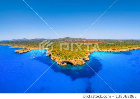 Aerial view of scenic Mallorca beach and azure bay with boats and yachts in Spain. Aerial view of scenic Mallorca beach and azure bay with boats and yachts in Spain. 139368863