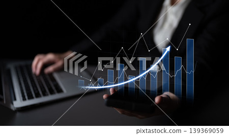 Businessman analyzing growth trends on digital devices with graphs and analytics on smartphone and laptop in modern office setting Scalp Businessman analyzing growth trends on digital devices with graphs and analytics on smartphone and laptop in modern office setting Scalp 139369059
