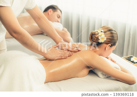 Caucasian couple customer enjoying relaxing anti-stress massage. Quiescent Caucasian couple customer enjoying relaxing anti-stress massage. Quiescent 139369118