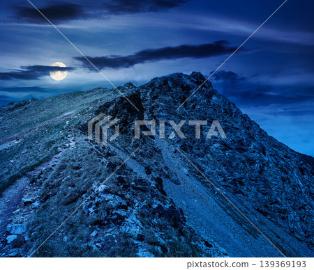 mountain scenery in summer at night. gorgeous mountainous landscape. background with rocky cliffs and grassy hillsides under a cloudy sky. full moon over ridge of mysterious mountains mountain scenery in summer at night. gorgeous mountainous landscape. background with rocky cliffs and grassy hillsides under a cloudy sky. full moon over ridge of mysterious mountains 139369193