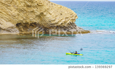 Kayaker fishing in clear blue water on a sunny day in the ocean 139369297