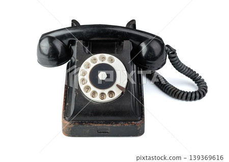 Vintage black phone isolated on a white background. Vintage black phone isolated on a white background. 139369616