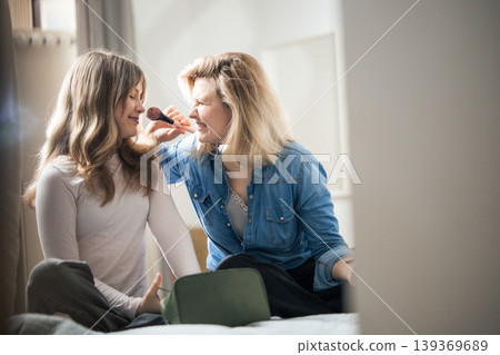 Mother and daughter having fun applying makeup at home Mother and daughter having fun applying makeup at home 139369689
