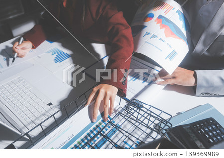 business people or accountant using calculator while working analytical business report on the workplace, accounting concept, Serious and focused financier accountant on paper work inside office, business people or accountant using calculator while working analytical business report on the workplace, accounting concept, Serious and focused financier accountant on paper work inside office, 139369989