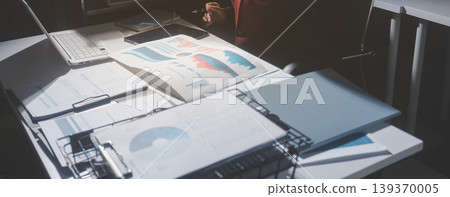 business people or accountant using calculator while working analytical business report on the workplace, accounting concept, Serious and focused financier accountant on paper work inside office, business people or accountant using calculator while working analytical business report on the workplace, accounting concept, Serious and focused financier accountant on paper work inside office, 139370005