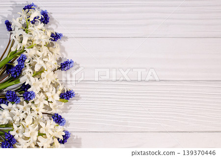 Abstract floral arrangement of spring flowers for a web design and template. A beautiful flyer with white hyacinths and blue muscari on an elegant, vibrant background. Abstract floral arrangement of spring flowers for a web design and template. A beautiful flyer with white hyacinths and blue muscari on an elegant, vibrant background. 139370446