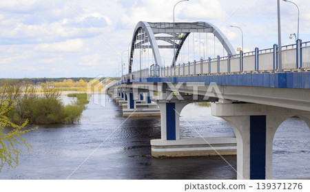 Arch bridge over the river during spring flood Arch bridge over the river during spring flood 139371276