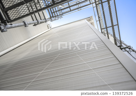 A view looking up at the new exterior siding of a detached house. A view looking up at the new exterior siding of a detached house. 139372526