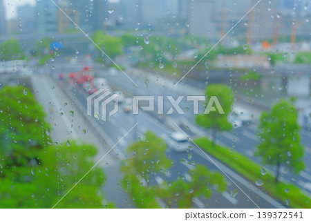 Rainy cityscape visible from the window Rainy cityscape visible from the window 139372541